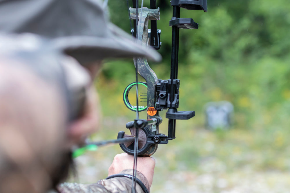 Compound archer shoots an arrow through a bow.