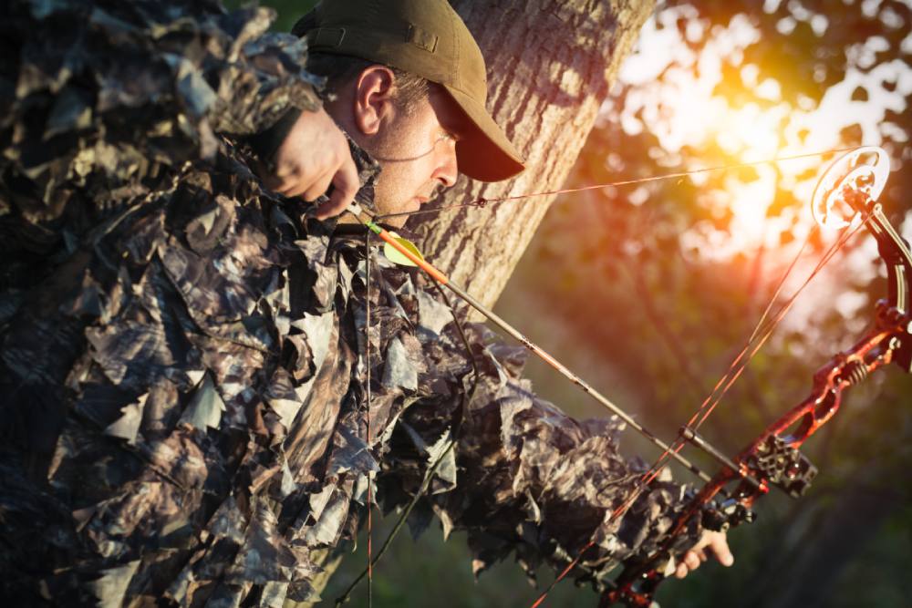 A hunter drawing back a bow string