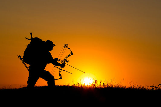 silhouette of a bow hunter at sunset.